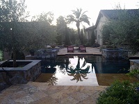 pool deck with inlay design and natural stone paver tile